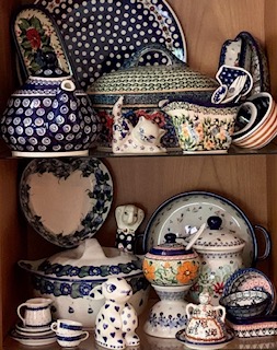 Assortment of vintage ceramic teapots and porcelain dishes with intricate patterns, ideal for antique kitchen decor.